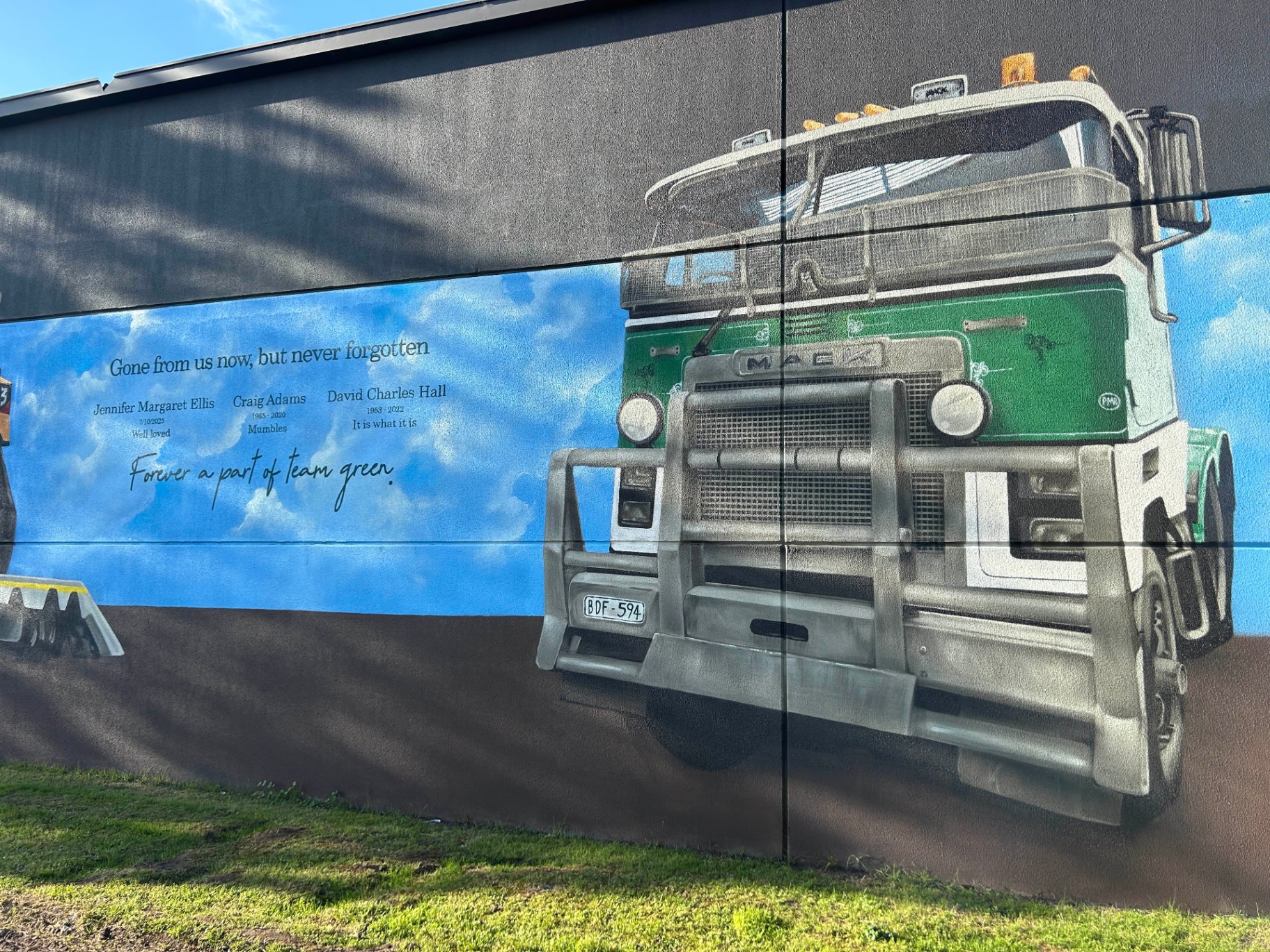 Mack truck mural detail with memorial dedication panel