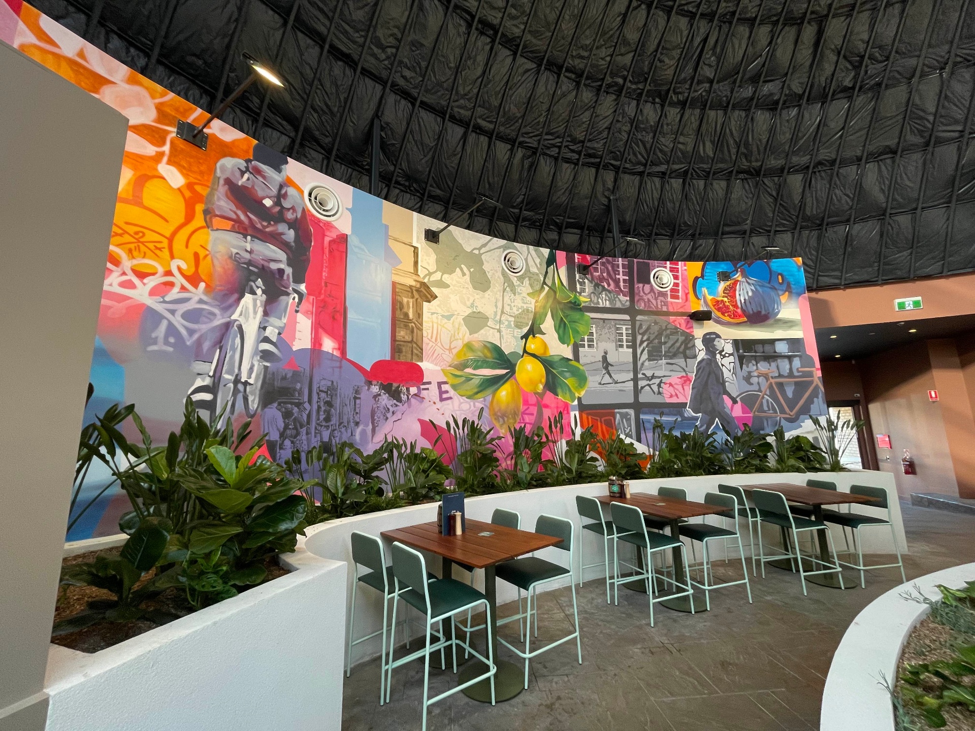 Moreland Hotel curved mural with cyclist and lemons