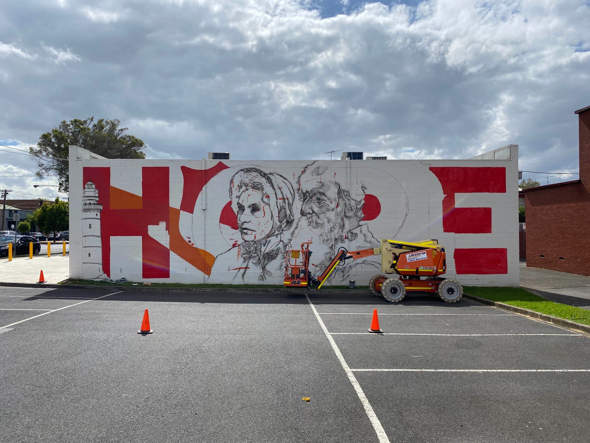 HOPE mural in progress with red letterforms and portrait line work