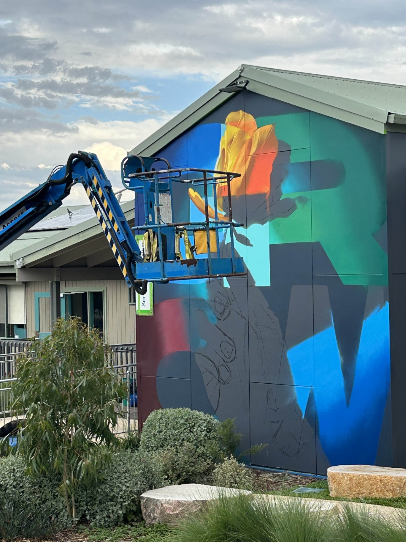 Mural production stage with lifting equipment on site
