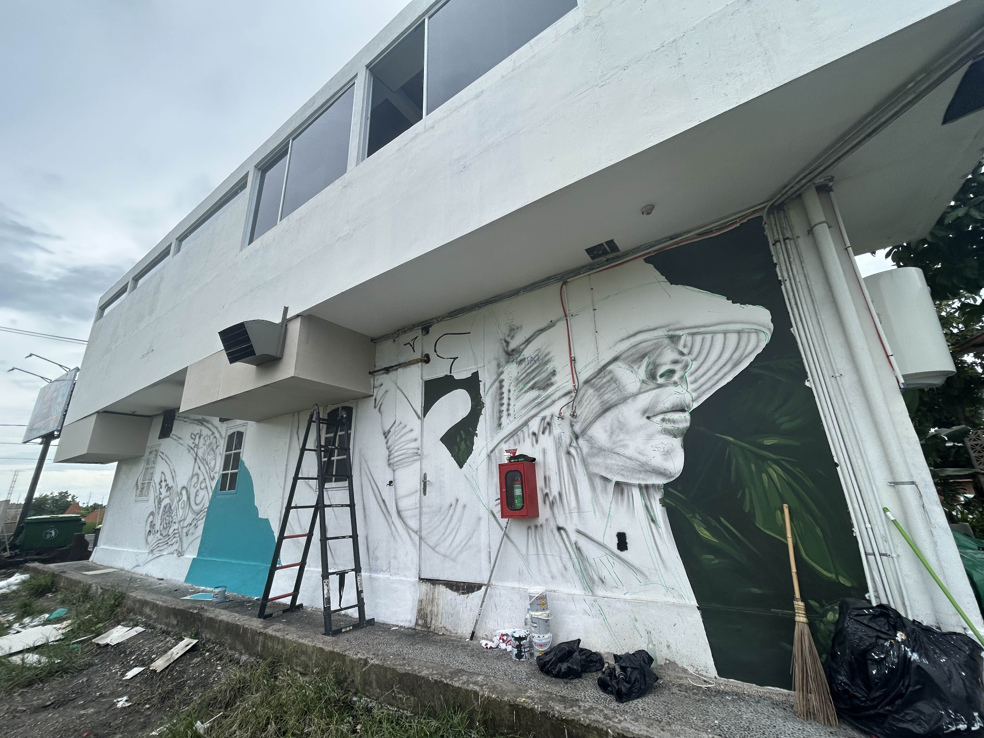 Painted portrait detail with boom lift on site