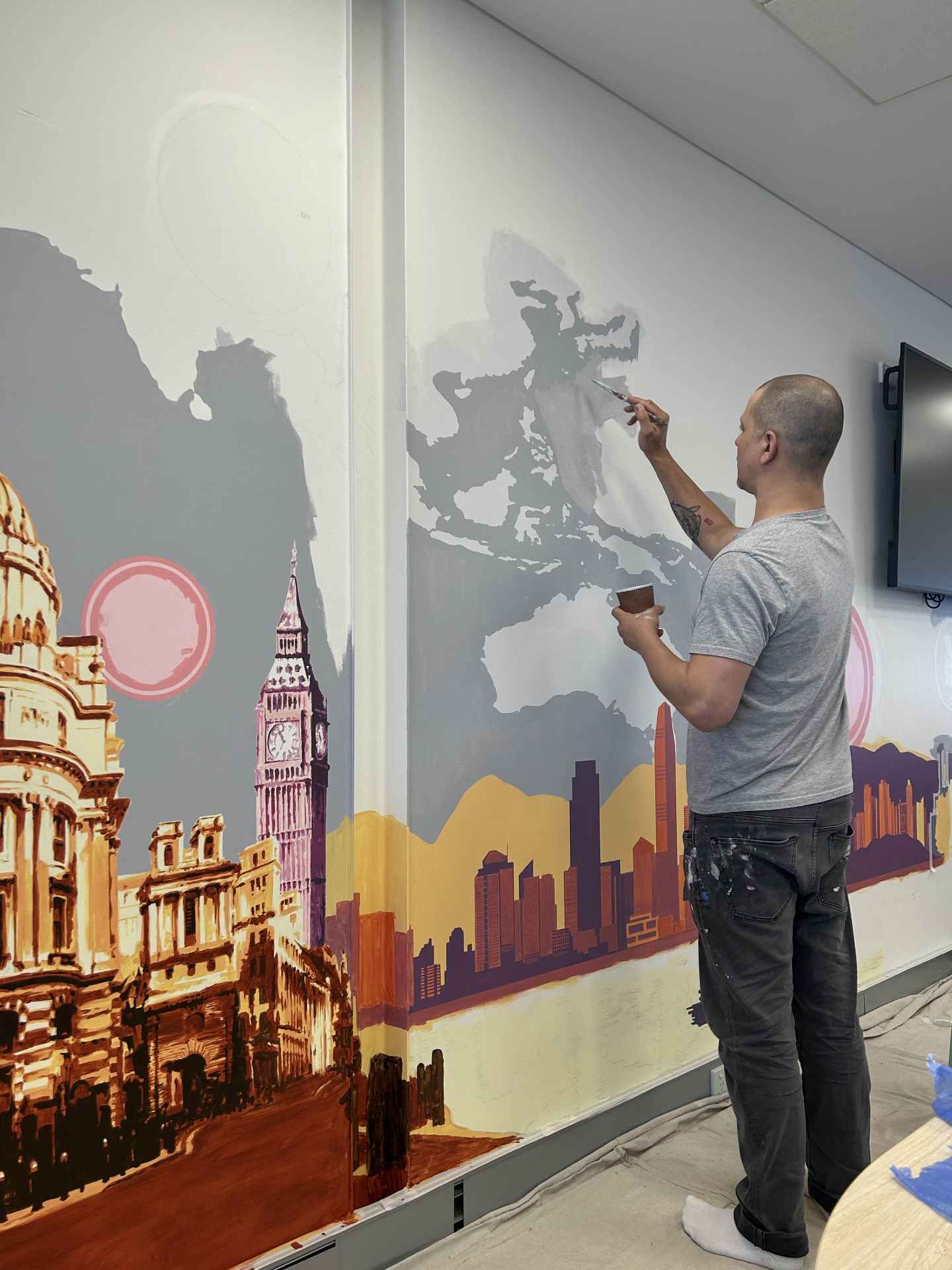 Artist painting Asia map section of the Bloomberg Economics Lab mural