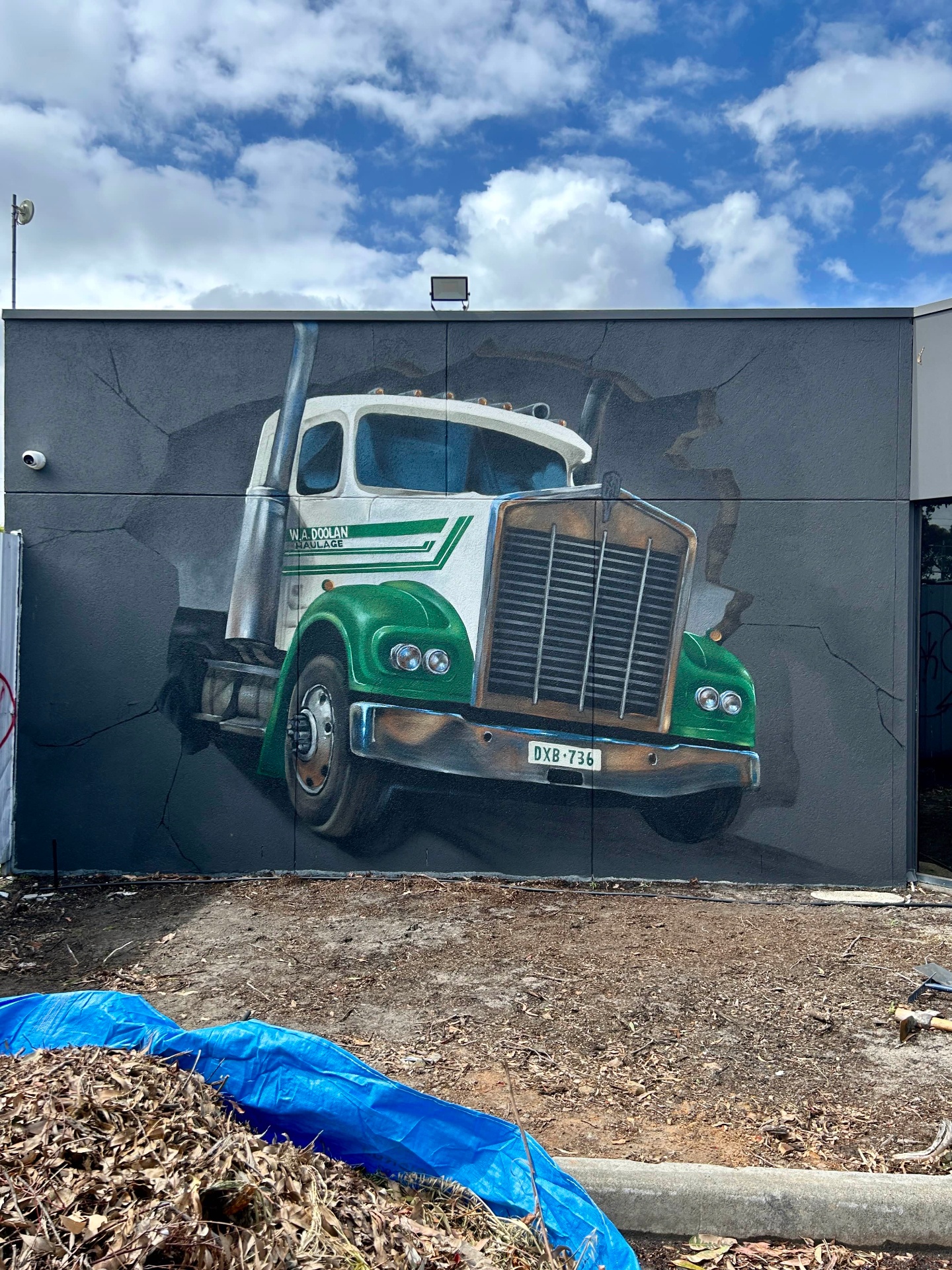 Vintage W.A. Doolan Haulage truck mural bursting through the wall